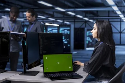 Computer scientist using green screen notebook to oversee blade servers Stock Photos