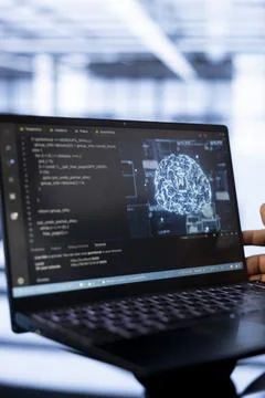 Computer scientist using laptop in data center, updating AI Foto stock