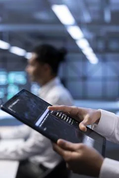Computer scientist using tablet, optimizing data center performance, close up Stock Photos