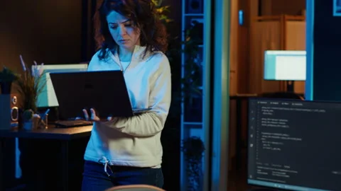 Computer scientist walking at home, developing software using laptop Stock Footage 283692721