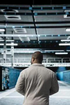 Computer scientist walking in server farm, overseeing mainframes gear 스톡 사진