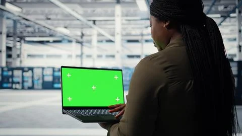 Computer scientist at work using green screen laptop in data center Stock Photos