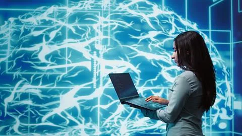 Computer scientist working on laptop, programming artificial intelligence Stock Photos