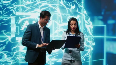 Computer scientists collaborating on developing AI system in high tech workspace Stock Footage 278697941