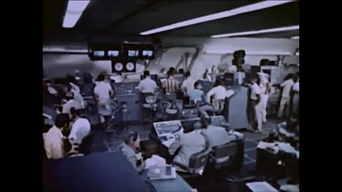 Computer scientists operate many computers in a room for the launch of a missile Stock Footage 86824427