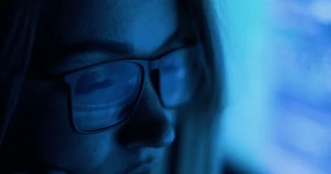 Computer screen and code reflected in woman's glasses Video stock 82918076