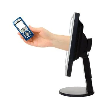 Computer screen and hand with phone Stock Photos