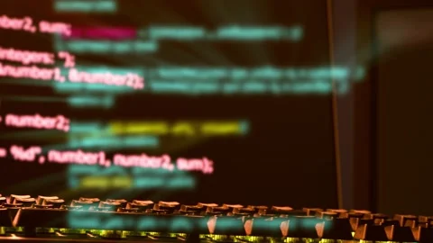 Computer screen and keyboard displaying programing code from a virus or 스톡 동영상 146467459
