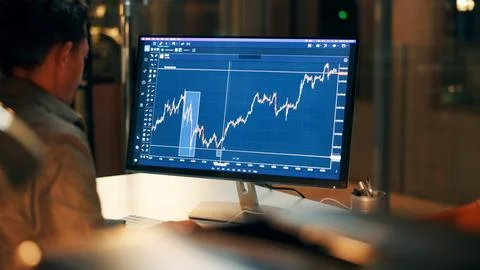 Computer, screen and man with graphs at night, data analysis or stock marke.. Stock Photos