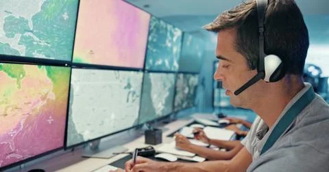 Computer, screen and man with headset in control room for storm tracking Stock Photos