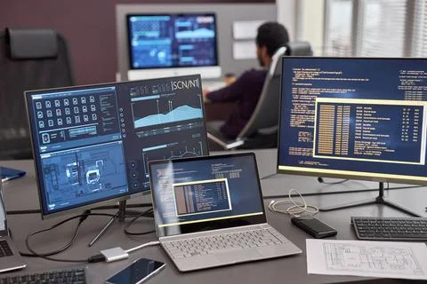 Computer screen with code lines and data on desk in IT development office Stock Photos