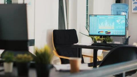 Computer screen in company workspace showing trading platform and pie charts Stock Photos