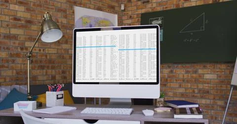 Computer screen with data processing standing on desk in office Foto stock