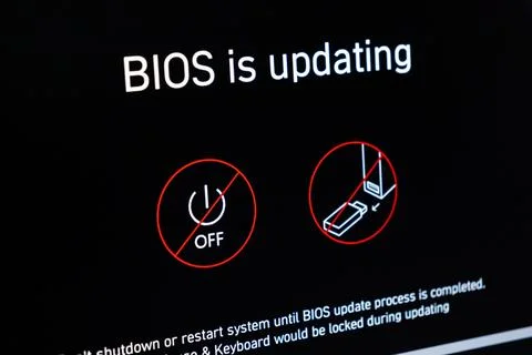 A computer screen displaying a BIOS update status warning to prevent powering 写真素材