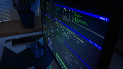 Computer Screen Displaying Cybersecurity Code in Dark Office Stock Footage 347285182