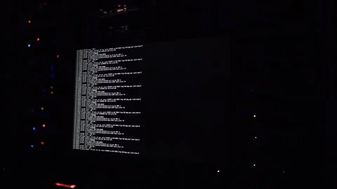 Computer screen displaying lines of server log data in a dark room with bli.. Stock Footage 339769703