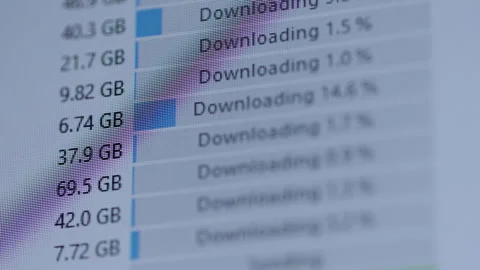 Computer screen displaying multiple files actively downloading, showing progress Stock Footage 318013804