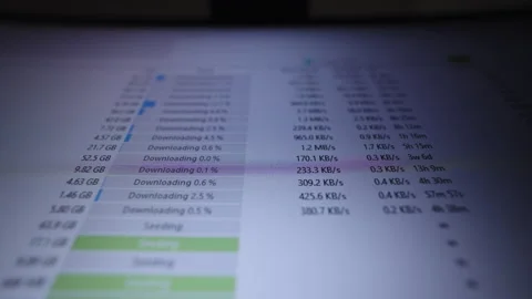Computer screen displaying p2p client application actively downloading and Stock Footage 321294676