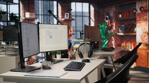 Computer screen in empty software development agency showing code Stock Photos