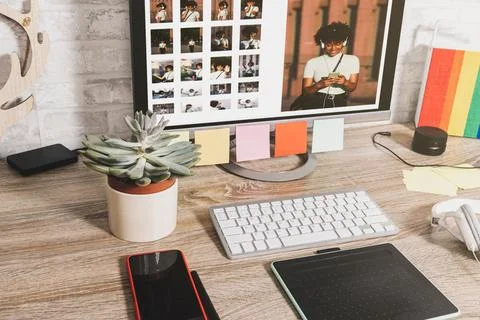 The computer screen has a bunch of things in it on a desk Stock Photos
