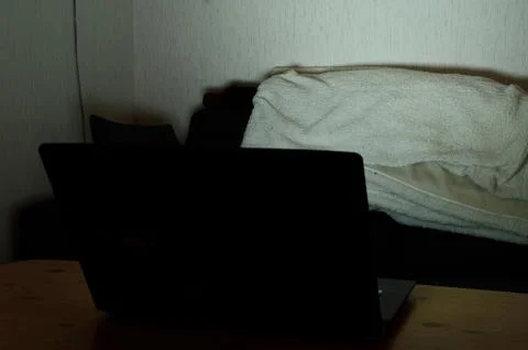 Computer screen illuminating room at night Stock Photos