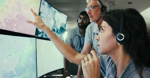 Computer screen, meteorology and team with people in control room for storm.. Stock Photos