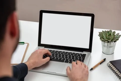 Computer screen mockup. Man working with a white blank screen laptop on a woo Stock Photos