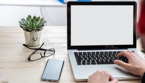 Computer screen mockup. Man working with a white blank screen laptop on a woo Stock Photos