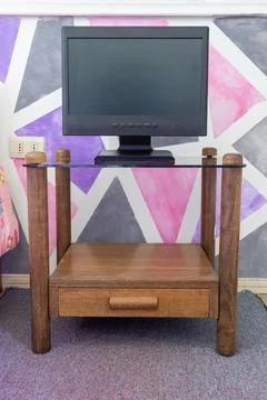 A computer screen on a nightstand Stock Photos