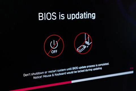 A computer screen showing a BIOS update progress bar with warning icons, Stockfoto's