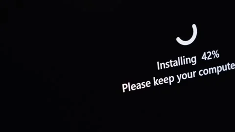 Computer screen shows Installing 42% and Please keep your computer on messa.. Stock Footage 314389081