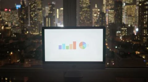 Computer screen standing on modern city office desk showing financial business Stock Photos