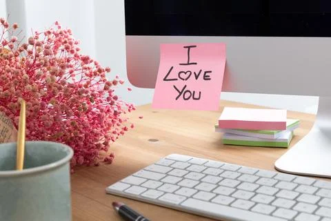 Computer Screen with a Sticky Note Saying I love you as a Romantic Message Stock Photos