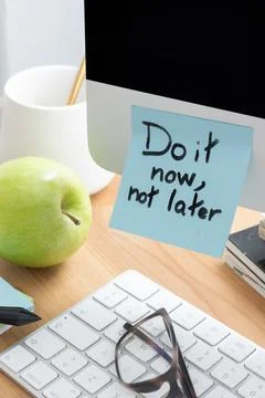 Computer Screen with Sticky Note Saying"Do It Now, Not Later" as a Motivati.. Stock Photos