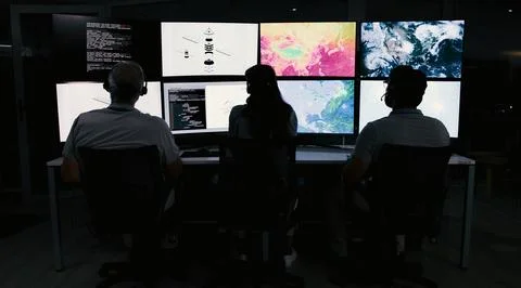 Computer screen, weather and back of people in control room for storm, rese.. Stock Photos