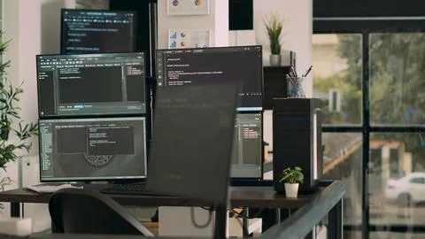 Computer screens on desk running programming code data algorithms 스톡 사진