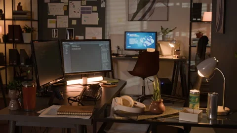 Computer Screens Displaying Code in Empty Programmer Office at Night 動画素材 336712491
