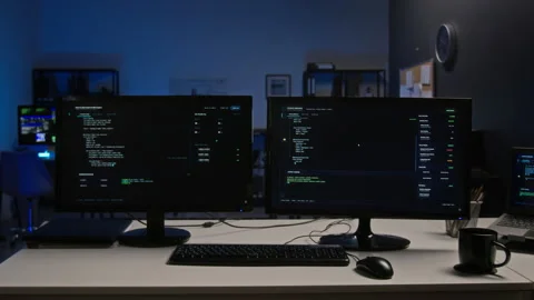 Computer Screens Displaying Cybersecurity Code in Dark Office Видео 347286717