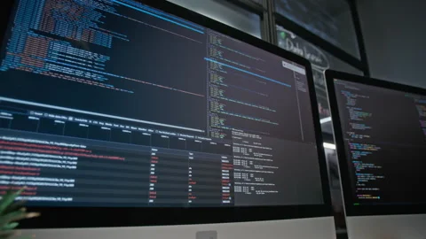 Computer Screens Displaying Programming Code in Modern Tech Office Stock Footage 348344661