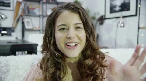 Computer screen's point of view of a attractive young woman using skype Stock Footage 12496242