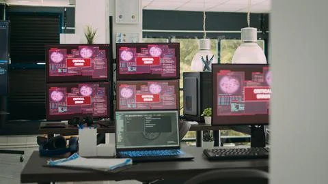Computer screens running hacking alert security breach in empty software it Stock Photos