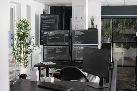 Computer screens showing parsing html code in empty it office Stock Photos