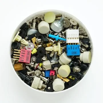 Computer screws and fasteners in box on white background. Computer repair Stock Photos