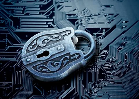 Computer security concept. Old mysterious padlock on computer circuit board Stock Photos