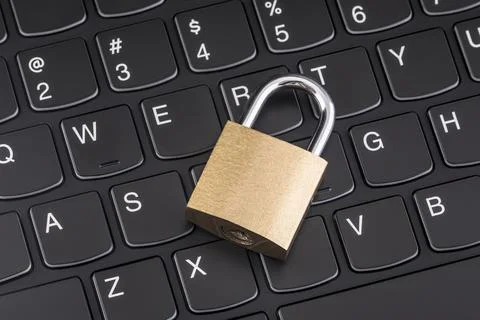 Computer security concept. Padlock on black laptop keyboard Stock Photos