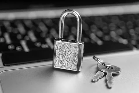 Computer security concept. Padlock on computer keyboard, laptop in office. Cy 写真素材