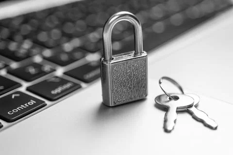 Computer security concept. Padlock with keys on computer keyboard, laptop in  Stock Photos