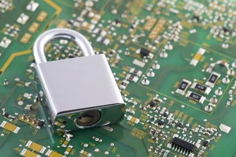 Computer security concept. Silver padlock on green computer circuit board Stock Photos