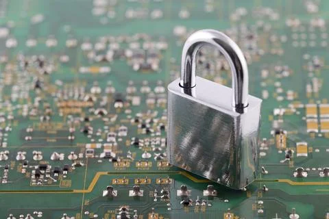 Computer security concept. Silver padlock on green computer circuit board 스톡 사진