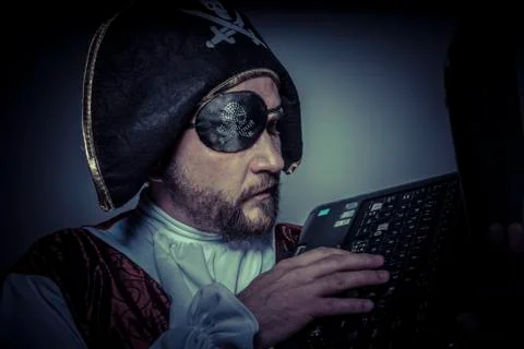 Computer security, hacker pirate dress with hat and skull Stock Photos